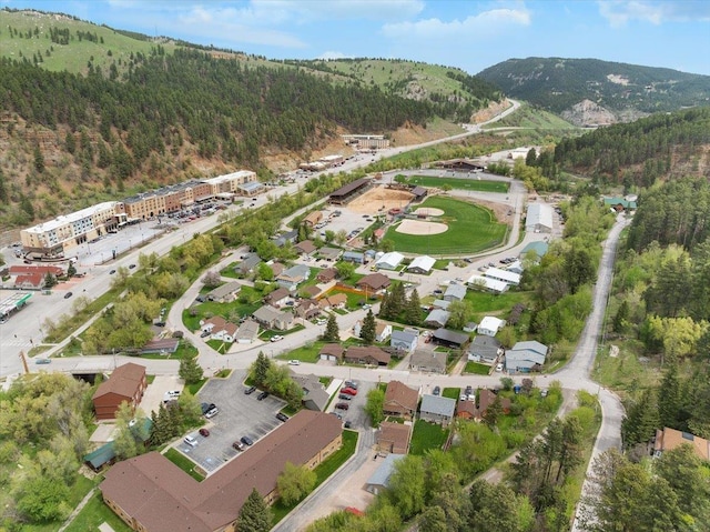 24 Mckinley St, Deadwood, SD 57732 - aerial overview of property's location featuring a heavily wooded area and a mountainous background