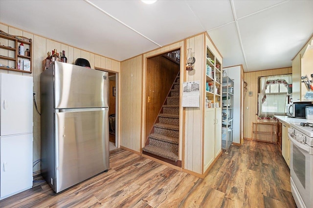 24 Mckinley St, Deadwood, SD 57732 - kitchen with stainless steel appliances, wooden walls, and wood finished floors