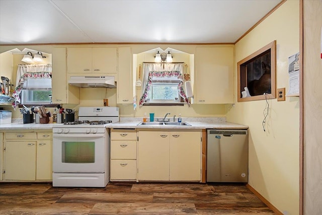 24 Mckinley St, Deadwood, SD 57732 - kitchen featuring cream cabinets, white gas range, a sink, and ornamental molding