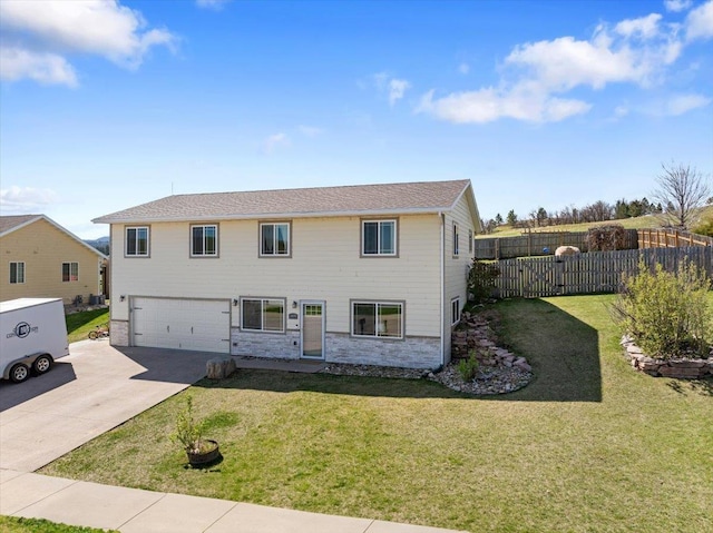 view of front of property featuring concrete driveway, an attached garage, and stone siding