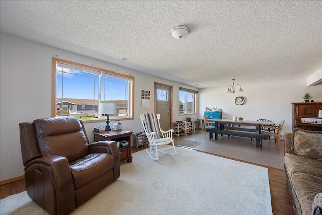 living area with a textured ceiling and wood finished floors