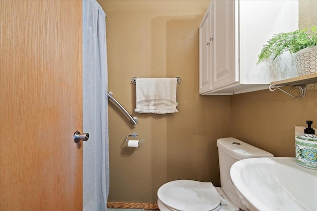 bathroom featuring a sink and toilet