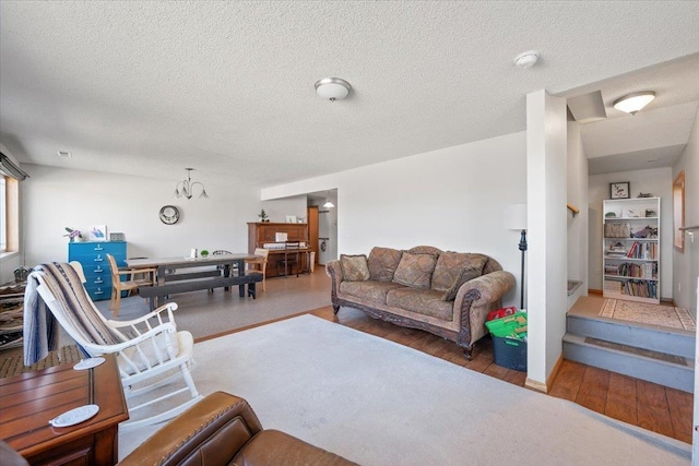 living area with wood finished floors and a textured ceiling