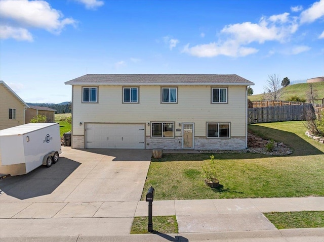 view of front of home featuring a garage, concrete driveway, and stone siding