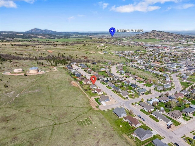 aerial view of property and surrounding area with mountains