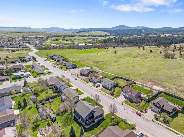 aerial view of property and surrounding area with mountains and nearby suburban area