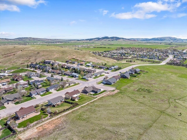 aerial overview of property's location featuring nearby suburban area and a mountainous background