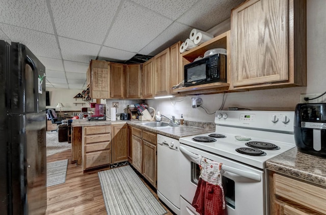 12944 Larene Dr, Black Hawk, SD 57718 - kitchen featuring black appliances, a sink, a paneled ceiling, light wood-style flooring, and a peninsula
