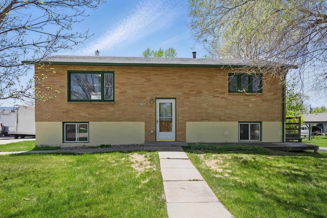 5753 Pluto St, Rapid City, SD 57703 - view of front facade featuring a front lawn, brick siding, and a wooden deck