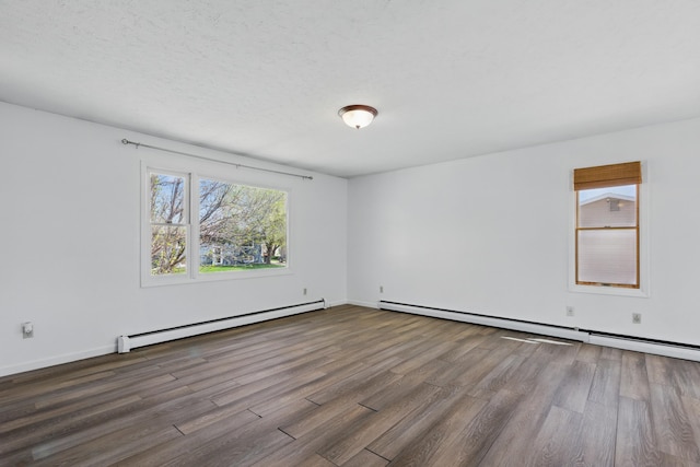 5753 Pluto St, Rapid City, SD 57703 - empty room with a baseboard heating unit, wood finished floors, and baseboards