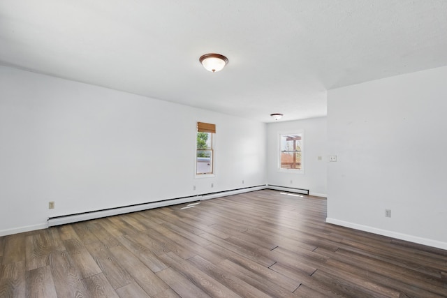 5753 Pluto St, Rapid City, SD 57703 - unfurnished room featuring wood finished floors, baseboards, and a baseboard radiator