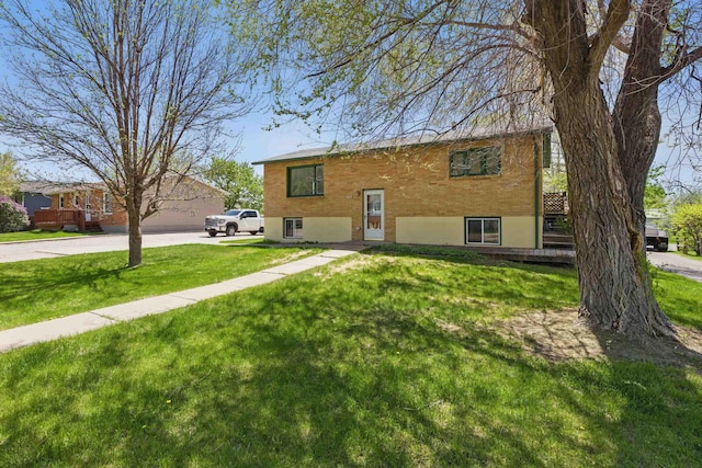 5753 Pluto St, Rapid City, SD 57703 - view of front of house with a front lawn and driveway