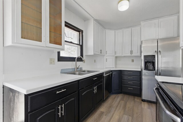 5753 Pluto St, Rapid City, SD 57703 - kitchen with a sink, stainless steel appliances, white cabinets, light wood-type flooring, and glass insert cabinets