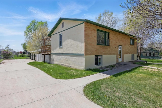 5753 Pluto St, Rapid City, SD 57703 - view of side of home with a yard and brick siding