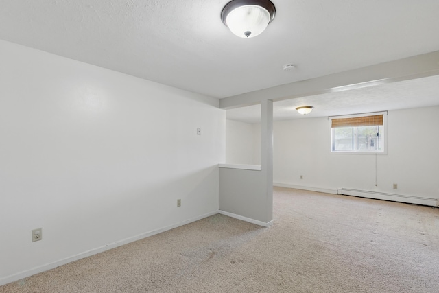 5753 Pluto St, Rapid City, SD 57703 - basement featuring a baseboard heating unit, carpet, and baseboards