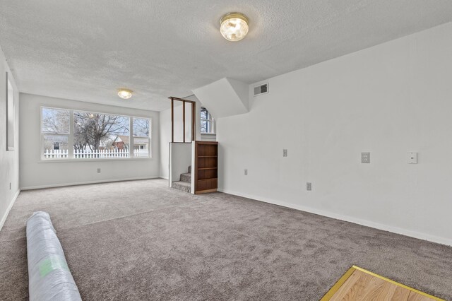 4648 Other, Rapid City, SD 57703 - unfurnished living room with a textured ceiling, carpet floors, stairs, and baseboards