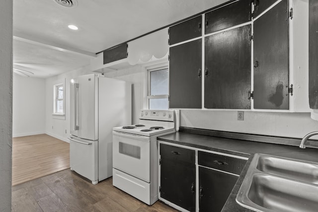 4648 Other, Rapid City, SD 57703 - kitchen with white appliances, a sink, dark countertops, dark cabinetry, and dark wood-style floors