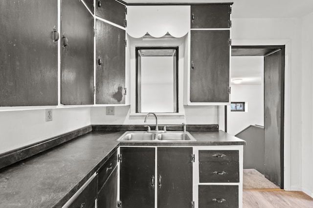 4648 Other, Rapid City, SD 57703 - kitchen featuring a sink, dark countertops, and wood finished floors