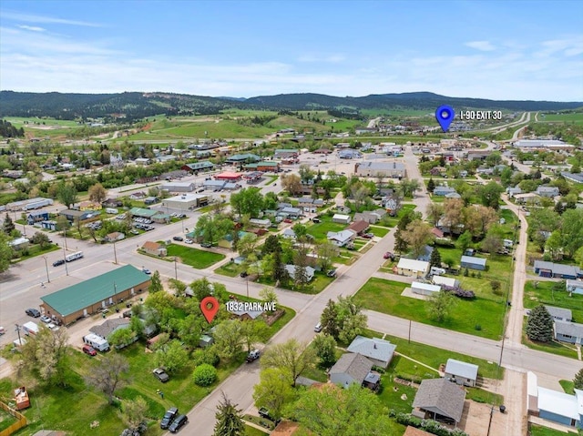 aerial view of property and surrounding area with mountains and nearby suburban area