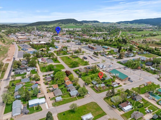 aerial overview of property's location featuring a mountainous background and nearby suburban area