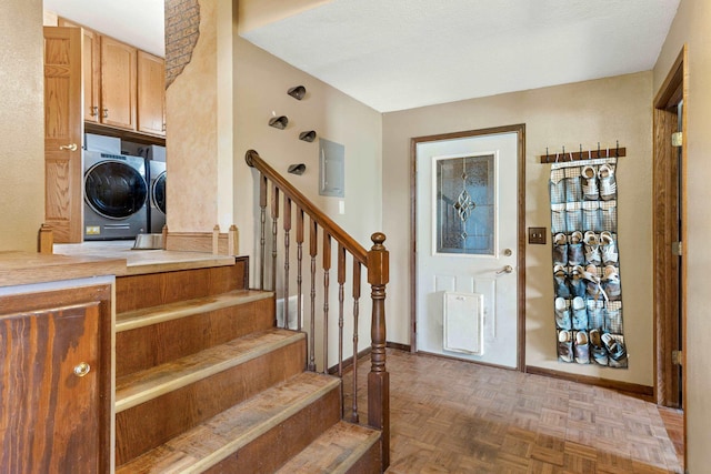 2030 12th Ave, Belle Fourche, SD 57717 - entryway featuring separate washer and dryer, stairs, and baseboards