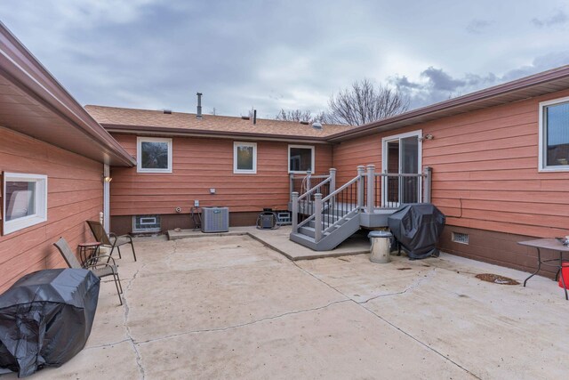 2030 12th Ave, Belle Fourche, SD 57717 - back of house featuring central AC and a patio area