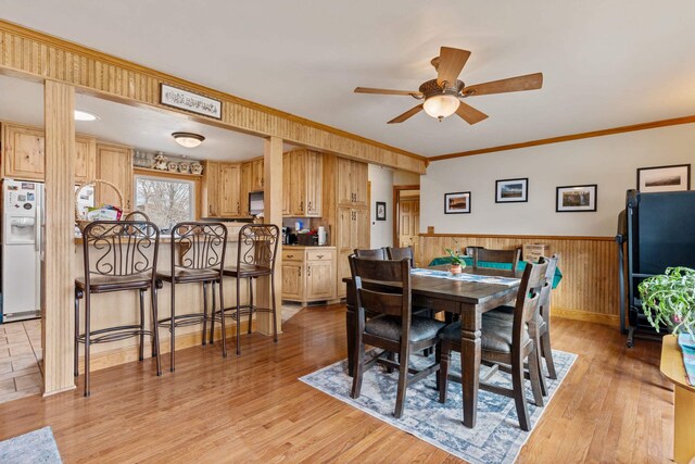2030 12th Ave, Belle Fourche, SD 57717 - dining space featuring ceiling fan, light wood-style floors, wainscoting, and ornamental molding