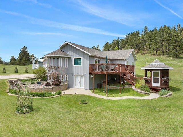 1129 Foothills Rd, Sturgis, SD 57785 - back of house with a deck, a lawn, french doors, and stairway