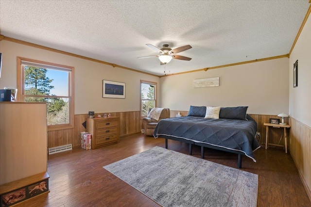 376 Lone Elk Rd, Spearfish, SD 57783 - bedroom with a wainscoted wall, wood walls, a textured ceiling, wood finished floors, and ornamental molding