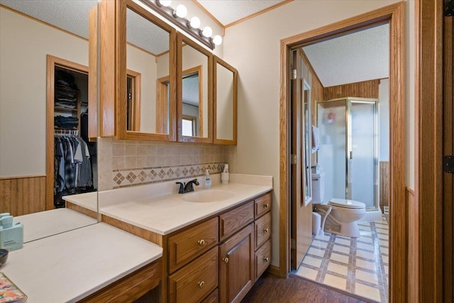 376 Lone Elk Rd, Spearfish, SD 57783 - full bathroom with a stall shower, toilet, tasteful backsplash, vanity, and ornamental molding