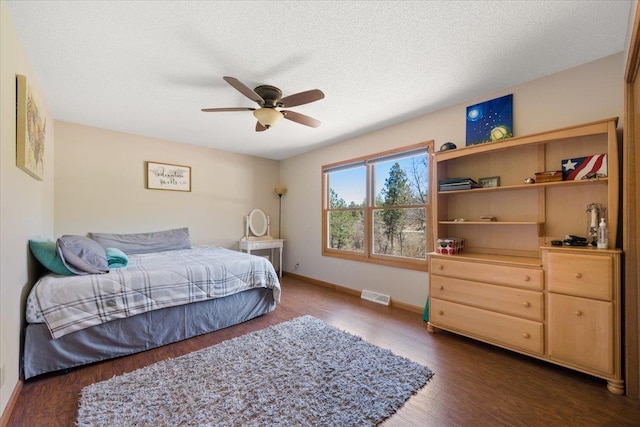 376 Lone Elk Rd, Spearfish, SD 57783 - bedroom featuring dark wood-type flooring, baseboards, a ceiling fan, and a textured ceiling