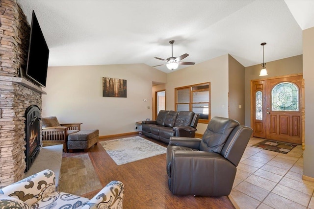376 Lone Elk Rd, Spearfish, SD 57783 - living area with lofted ceiling, baseboards, a fireplace, and a ceiling fan