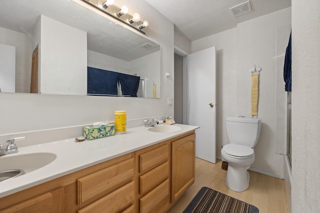 24227 Pine Grove Rd, Rapid City, SD 57702 - bathroom featuring toilet, wood finished floors, an enclosed shower, and double vanity