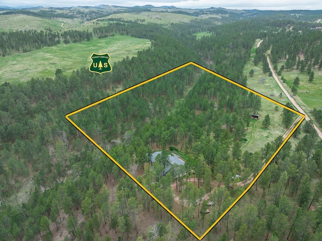24227 Pine Grove Rd, Rapid City, SD 57702 - aerial view of property's location featuring property parcel outlined, a heavily wooded area, and mountains