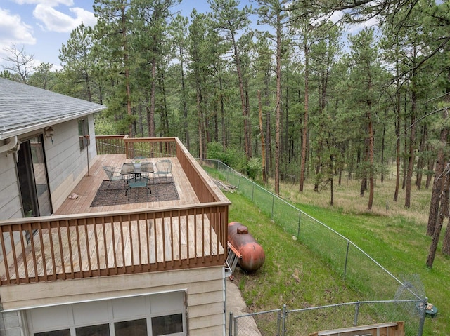 24227 Pine Grove Rd, Rapid City, SD 57702 - deck with outdoor dining space and a view of trees
