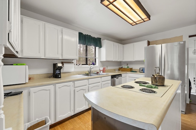 24227 Pine Grove Rd, Rapid City, SD 57702 - kitchen with a sink, appliances with stainless steel finishes, white cabinetry, and light countertops