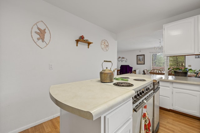 24227 Pine Grove Rd, Rapid City, SD 57702 - kitchen featuring electric range, light wood-style floors, white cabinetry, light countertops, and baseboards