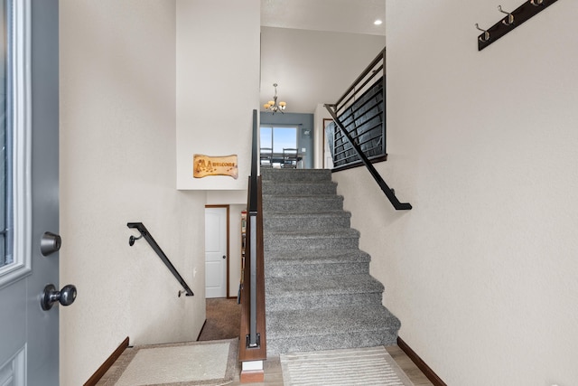3012 Allison Ln, Rapid City, SD 57703 - stairway with a chandelier, baseboards, and wood finished floors