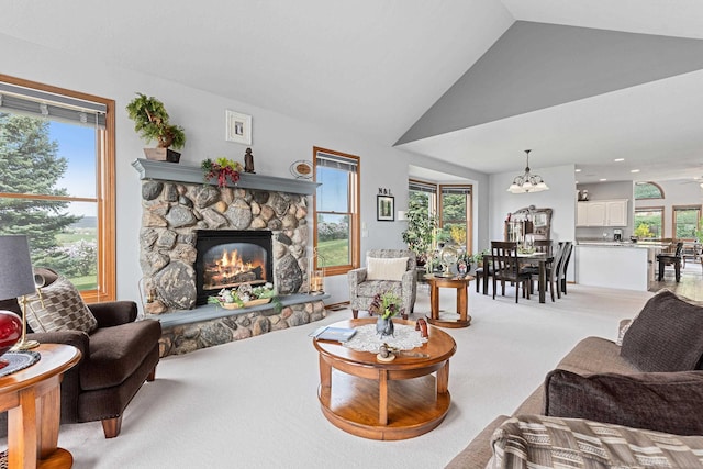 7725 Other, Rapid City, SD 57702 - living area with vaulted ceiling, light carpet, a fireplace, and a chandelier