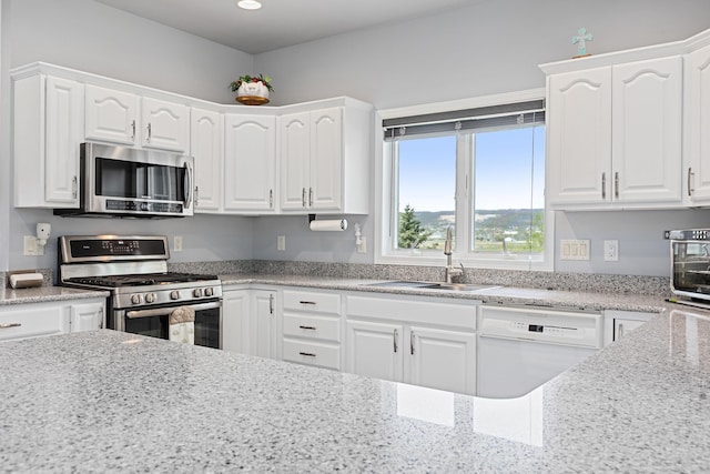 7725 Other, Rapid City, SD 57702 - kitchen with stainless steel appliances, a sink, white cabinetry, recessed lighting, and light stone counters