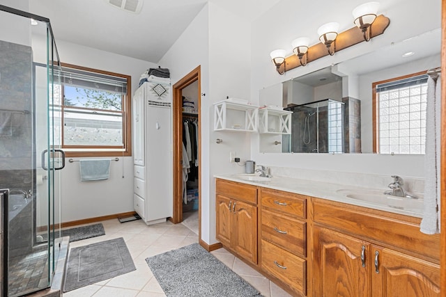 7725 Other, Rapid City, SD 57702 - full bath featuring a shower stall, a walk in closet, double vanity, tile patterned flooring, and baseboards