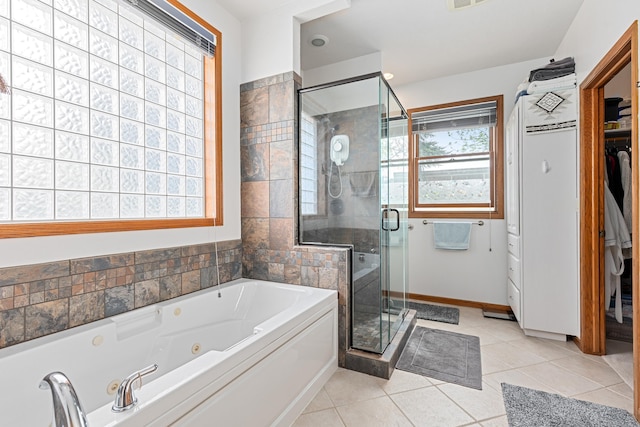 7725 Other, Rapid City, SD 57702 - full bathroom featuring a tub with jets, a shower stall, baseboards, tile patterned flooring, and a spacious closet