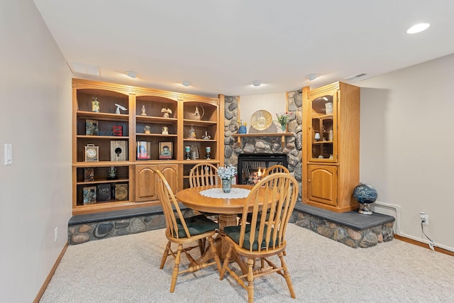 7725 Other, Rapid City, SD 57702 - dining area featuring carpet floors, a fireplace, and baseboards