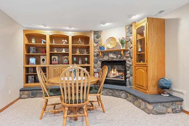 7725 Other, Rapid City, SD 57702 - carpeted dining room featuring a stone fireplace and baseboards