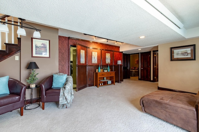 8510 Clarkson Rd, Rapid City, SD 57702 - carpeted living area with a textured ceiling, rail lighting, stairway, and baseboards