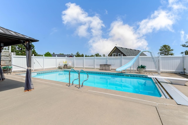 8510 Clarkson Rd, Rapid City, SD 57702 - view of swimming pool with a patio, a fenced backyard, and a water slide