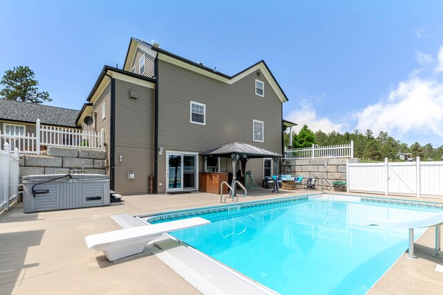 8510 Clarkson Rd, Rapid City, SD 57702 - view of pool featuring a hot tub, a patio area, a fenced backyard, a diving board, and a gazebo