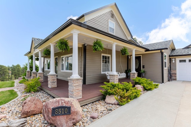 8510 Clarkson Rd, Rapid City, SD 57702 - view of front of home featuring a porch, concrete driveway, a garage, and roof with shingles