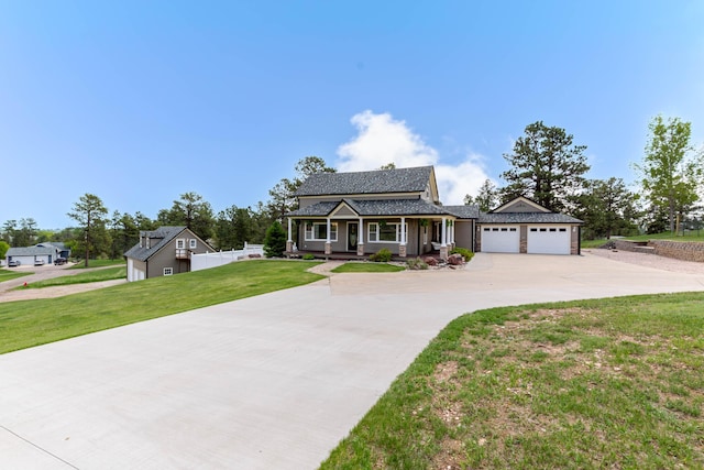 8510 Clarkson Rd, Rapid City, SD 57702 - view of front of house with covered porch, concrete driveway, a front lawn, and a garage