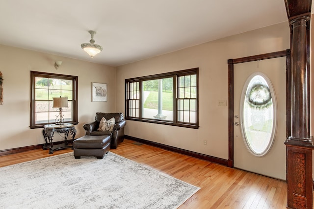 8510 Clarkson Rd, Rapid City, SD 57702 - entryway featuring light wood-style flooring, healthy amount of natural light, baseboards, and decorative columns